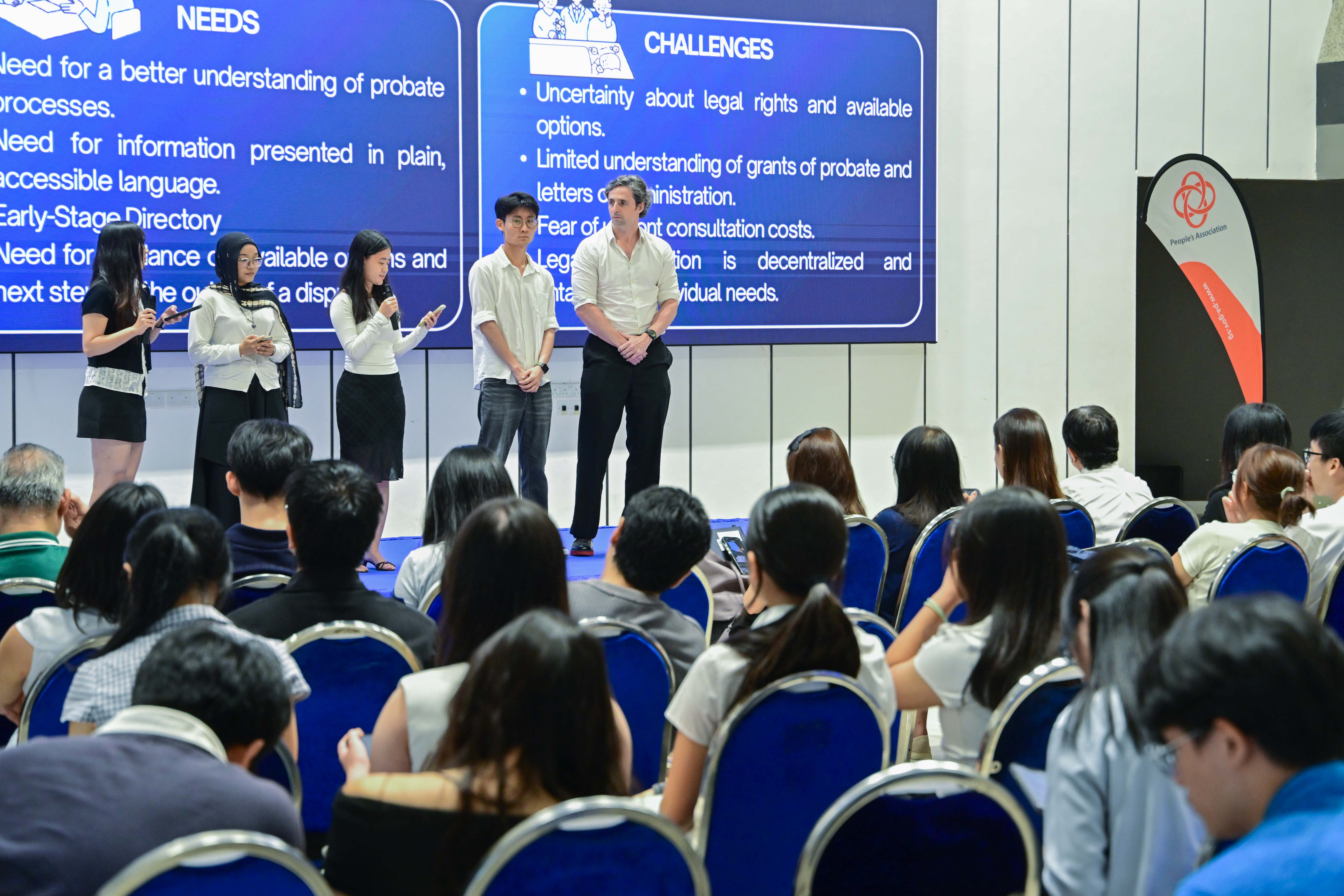 Five students explaining the needs and challenges of their group
